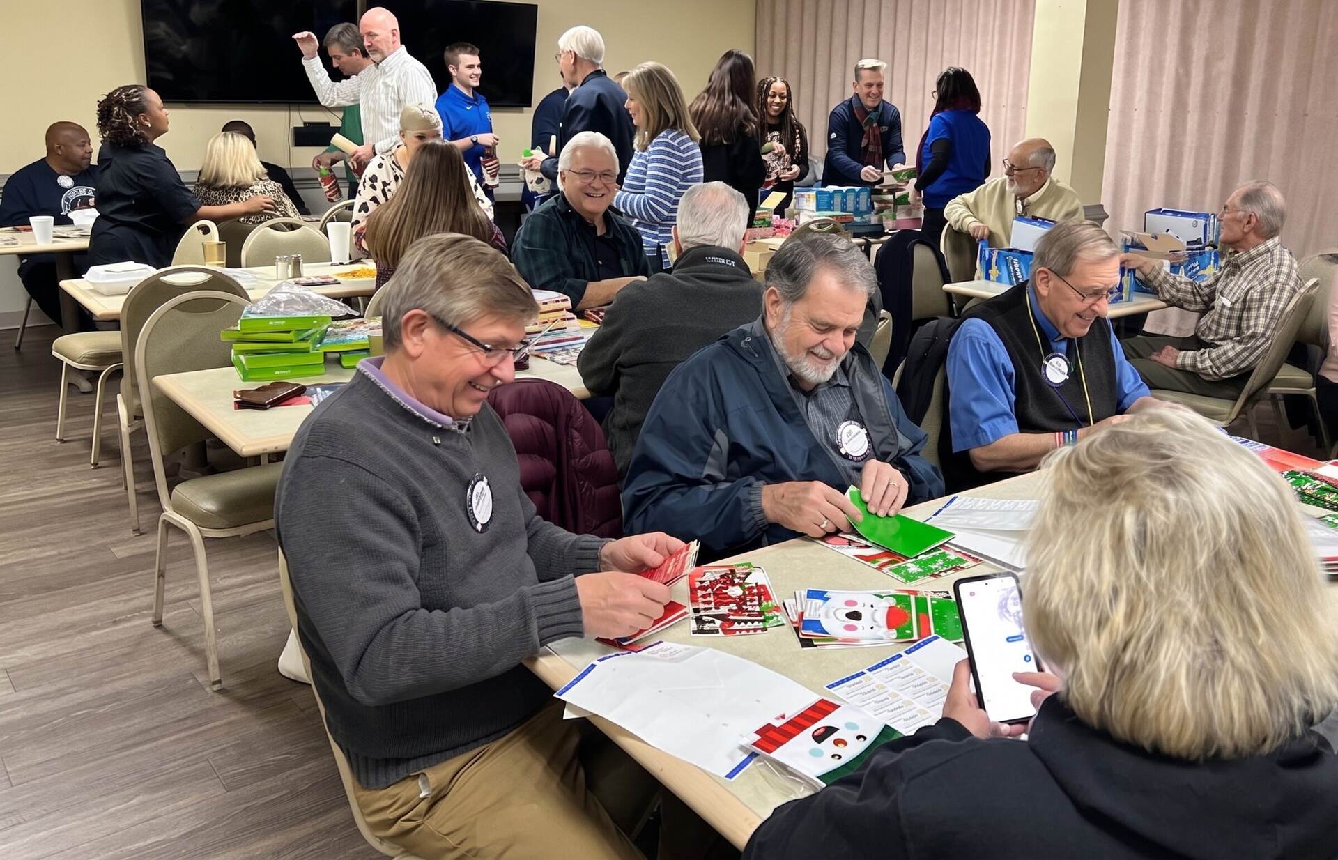 Wake Forest Rotary members assembling holiday care packages at a service project
